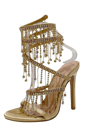 Goldene, glitzernde Riemchensandalen mit hohem Absatz und Quaste